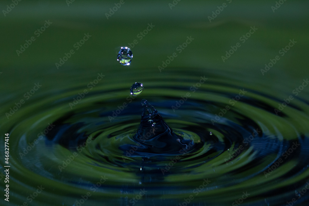 Photo of blue and green water droplets ejected from a water splash - stock photo Photo of blue and green water droplets ejected from a water splash - stock photo