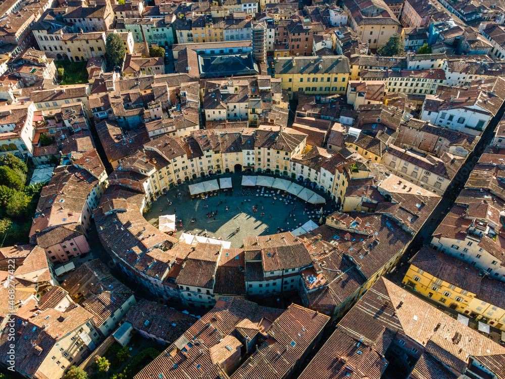 Aerial view of Piazza dell'Anfiteatro, a medieval square with cafè and market in Lucca old town, Tuscany, Italy.