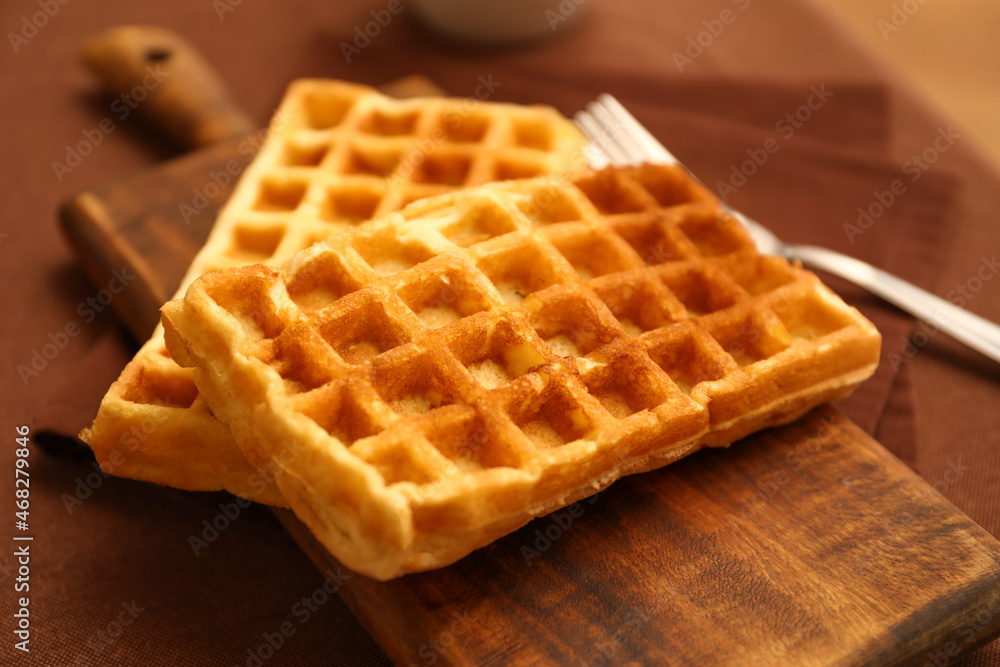 Wooden board of tasty Belgian Waffles on table in cafe Wooden board of tasty Belgian Waffles on table in cafe