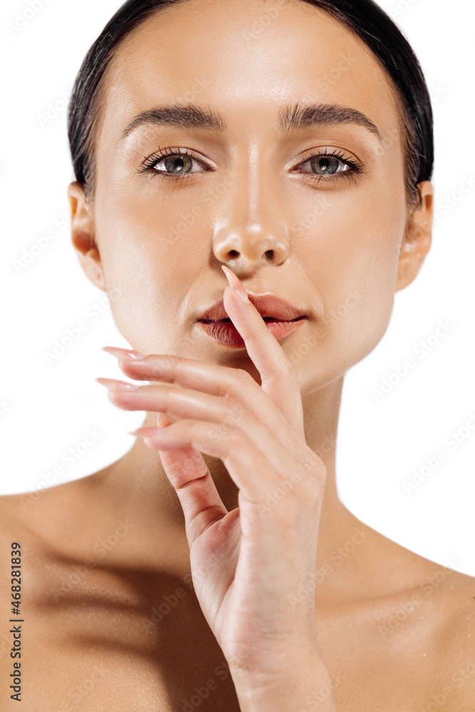 Young attractive woman with natural makeup on a white background, beautiful woman looking at the camera and smiling Young attractive woman with natural makeup on a white background, beautiful woman looking at the camera and smiling