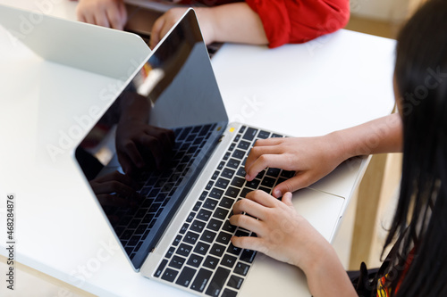 Children using laptop in classroom