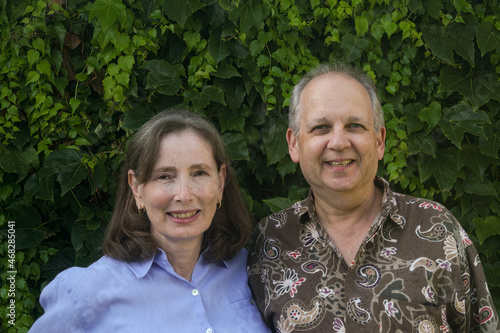 Faces of a happy couple in casual clothes looking toward  the camera