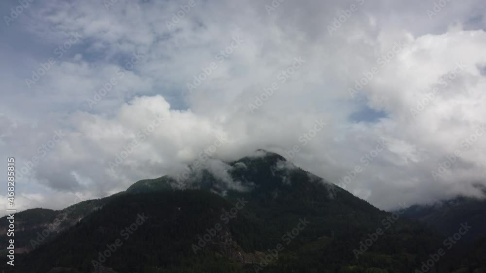 View from below the top of the mountain going into the thick clouds