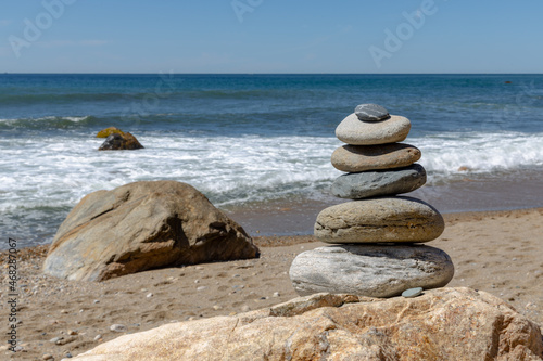 peaceful stack of rocks on a beach with waves
