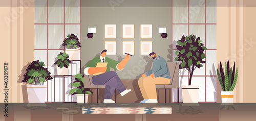 depressed man visiting psychologist male psychotherapist consulting patient during psychotherapy session mental health depression