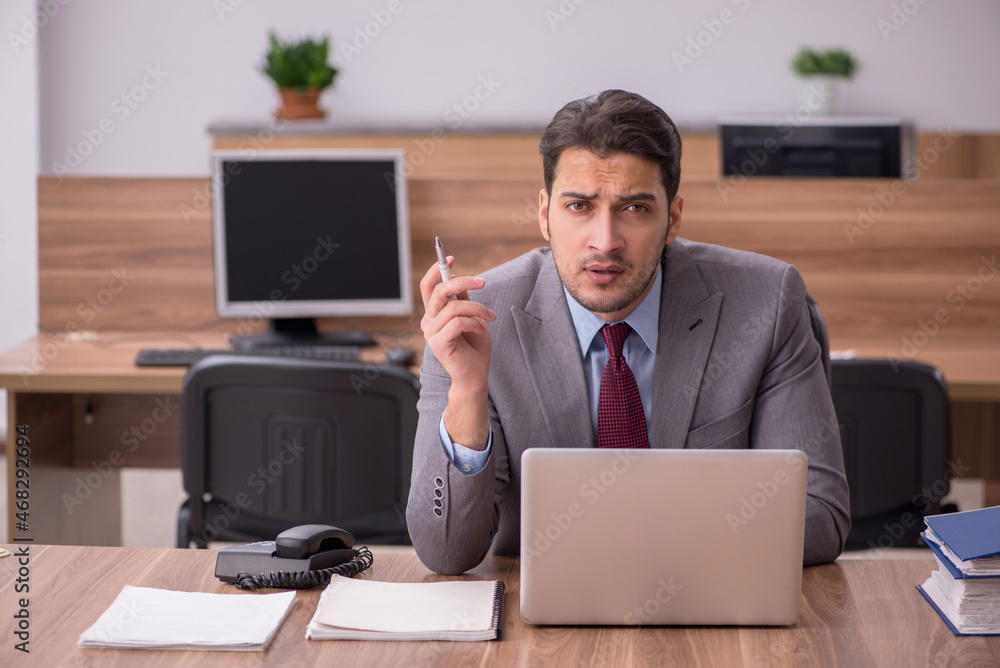 Young businessman employee working in the office Young businessman employee working in the office