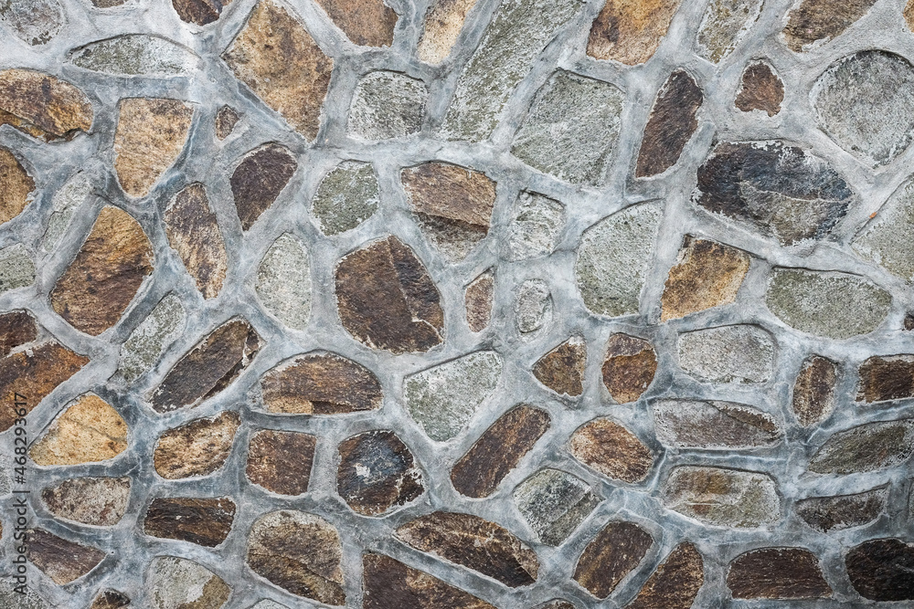 The texture of a stone wall made of stones of different sizes. Old castle stone wall texture background The texture of a stone wall made of stones of different sizes. Old castle stone wall texture background