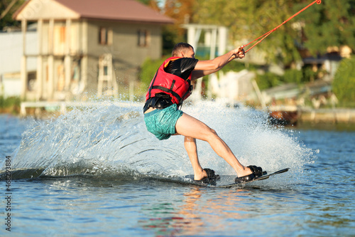 Fototapeta Naklejka Na Ścianę i Meble -  Man wakeboarding on river. Extreme water sport
