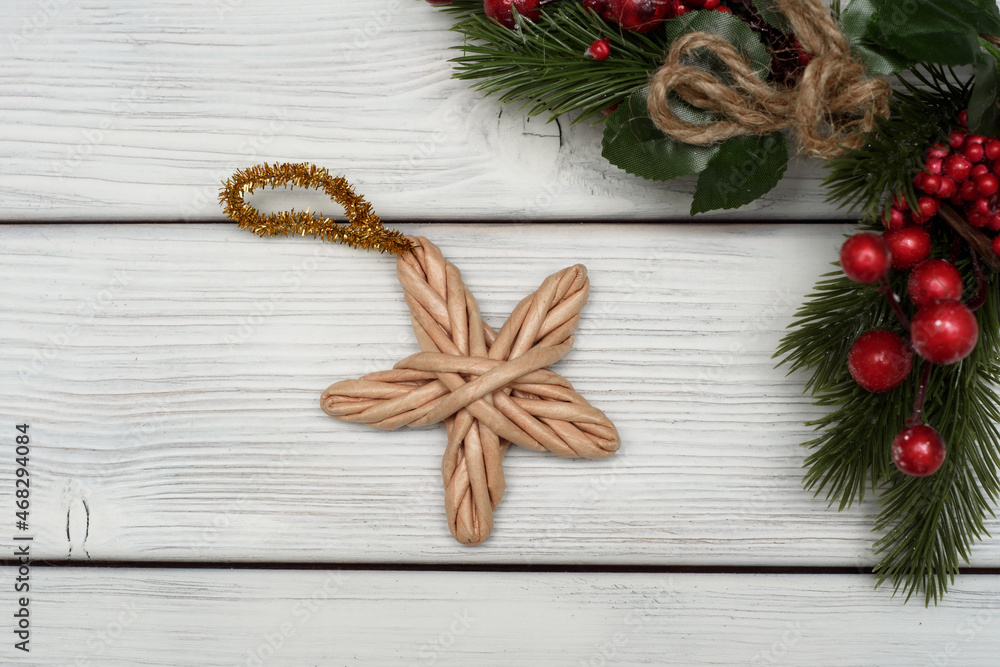 Christmas decoration wicker star made on white background.