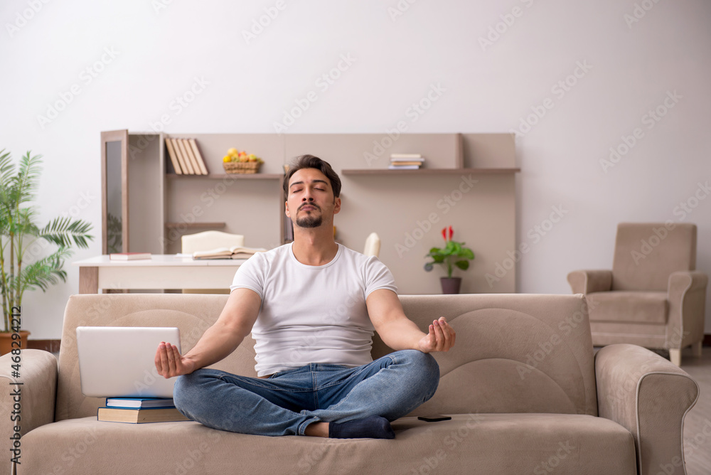 Young male student studying at home during pandemic Young male student studying at home during pandemic