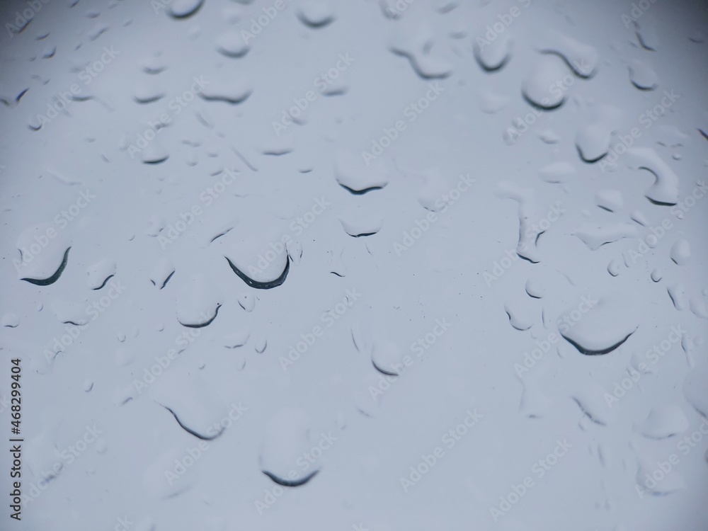 Drops of water drain on the window glass. A rainy day. Drops of water drain on the window glass. A rainy day.