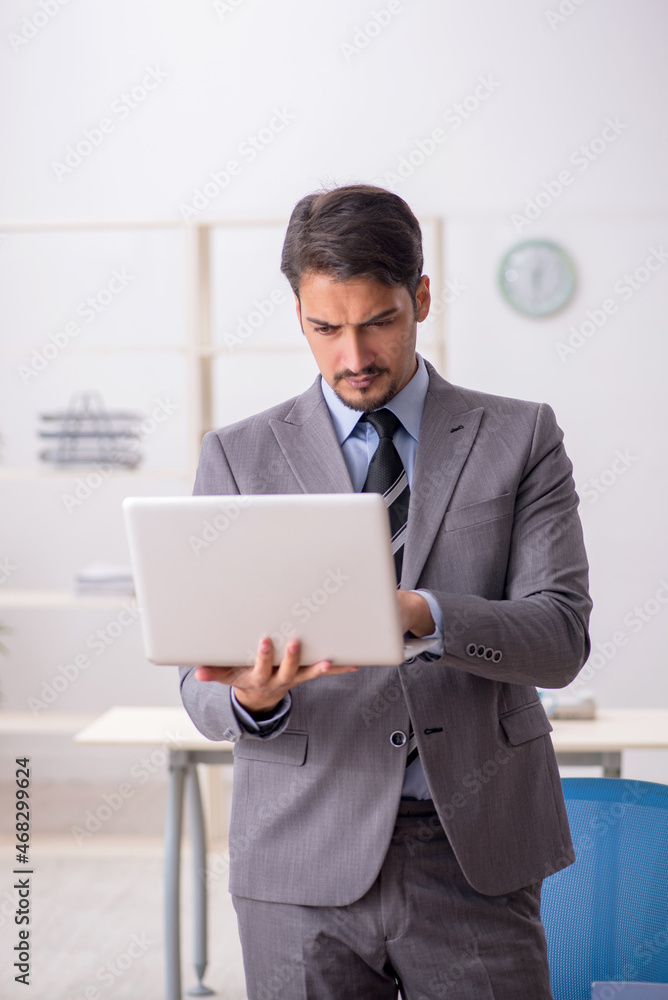 Young male employee working in the office Young male employee working in the office