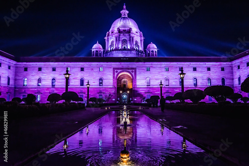 Colorful Secretariat Building in New Delhi India at night with reflection in the water photo