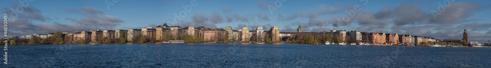 Panorama of the water front at Norr Mälarstrand on the island Kungsholmen with the Stockholm Town City Hall a sunny and color full autumn day in Stockholm