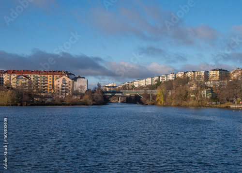 Apartment houses at the waterfront of the Stockholm islands Lilla Essingen and Kungsholmen with bridges connecting a sunny and color full autumn day in Stockholm
