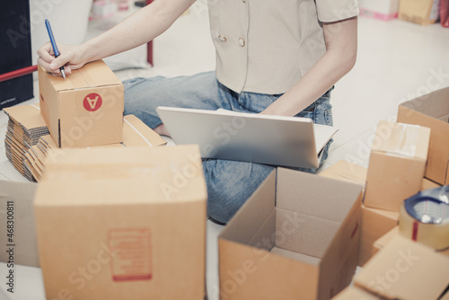 delivery and moving day concept - close up of loader writing something on clipboard in room after moving day