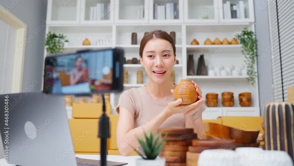Asian beautiful woman sell vase product online live streaming at home. Asian beautiful woman sell vase product online live streaming at home.