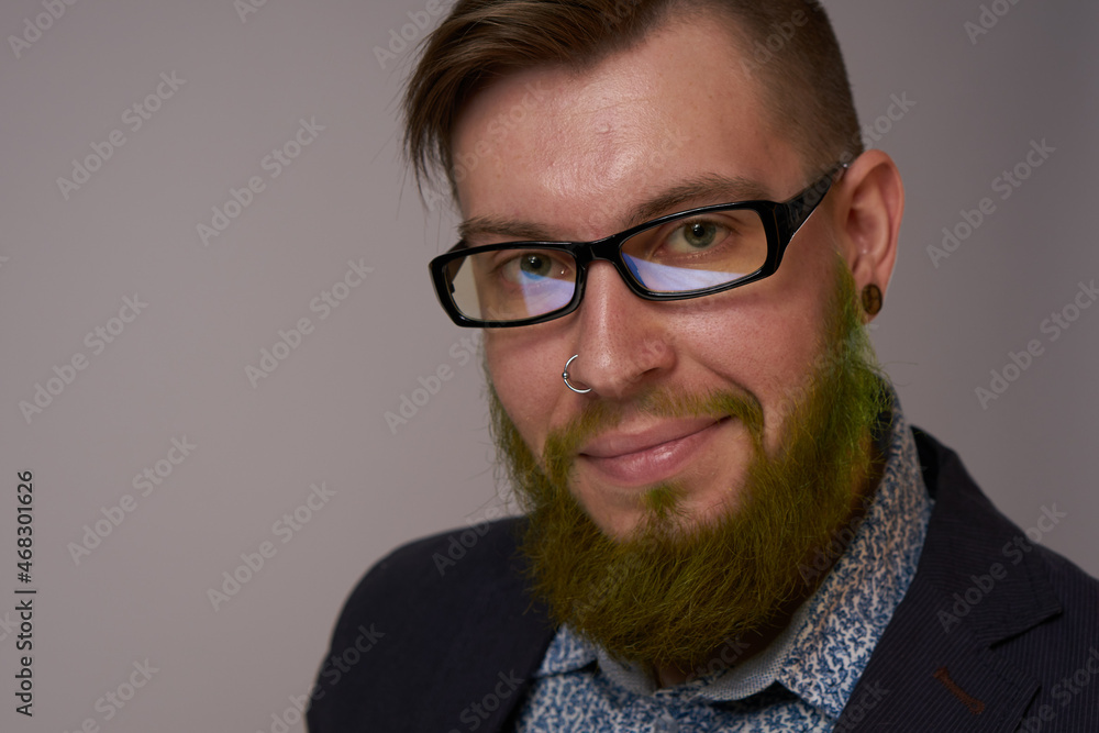 portrait of a business man wearing glasses with a beard posing an official