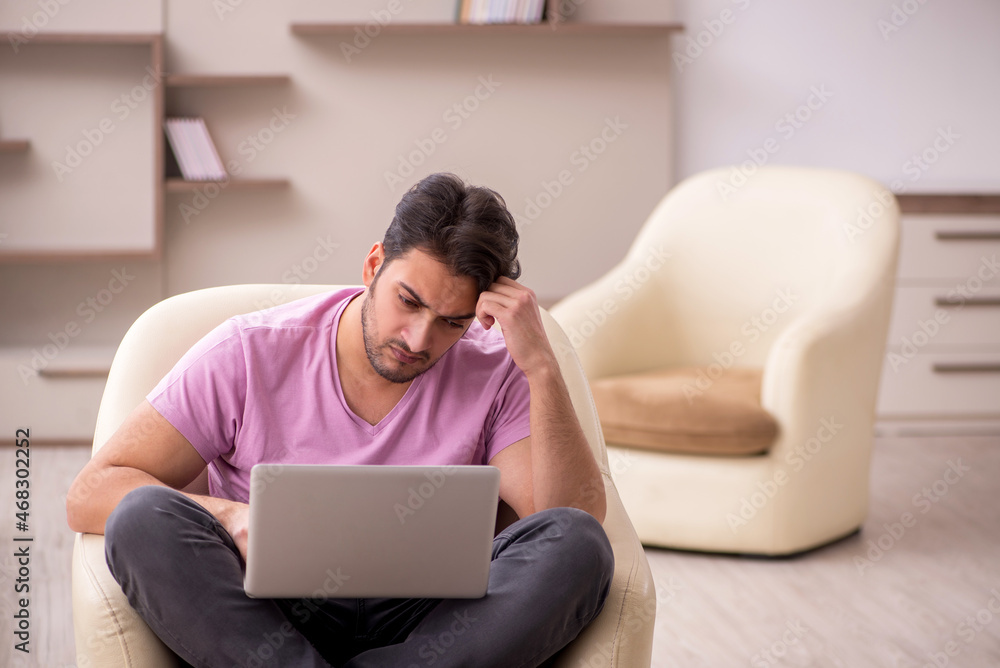 Young man working from home during pandemic Young man working from home during pandemic