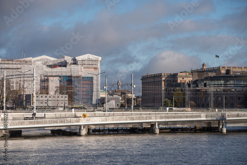 Train and footbridge in front of the Government Offices under reconstruction and the Swedish Parliament a sunny autumn day in Stockholm © Hans Baath