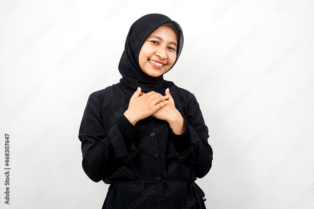 Beautiful young asian muslim woman smiling surprised and cheerful, with hands holding chest, excited, not expecting, looking at camera isolated on white background Beautiful young asian muslim woman smiling surprised and cheerful, with hands holding chest, excited, not expecting, looking at camera isolated on white background