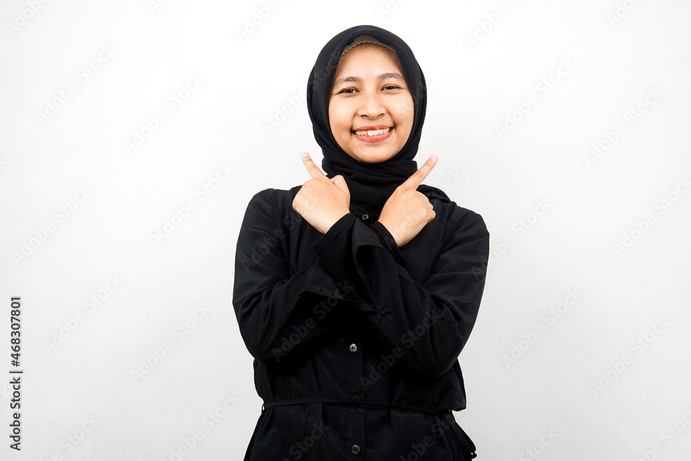 Beautiful young asian muslim woman smiling confident, enthusiastic, cheerful with hands pointing empty space presenting something, looking at camera isolated on white background, advertising concept Beautiful young asian muslim woman smiling confident, enthusiastic, cheerful with hands pointing empty space presenting something, looking at camera isolated on white background, advertising concept