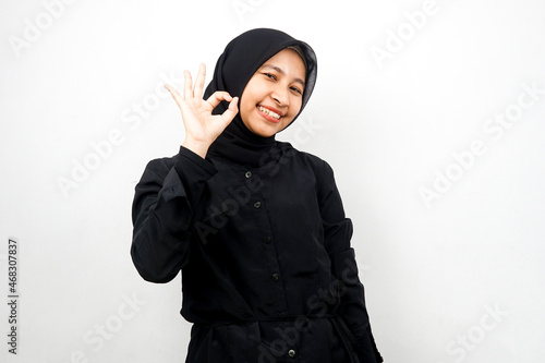 Beautiful young asian muslim woman smiling confident, enthusiastic and cheerful with hands ok sign, success, good job, success sign, isolated on white background