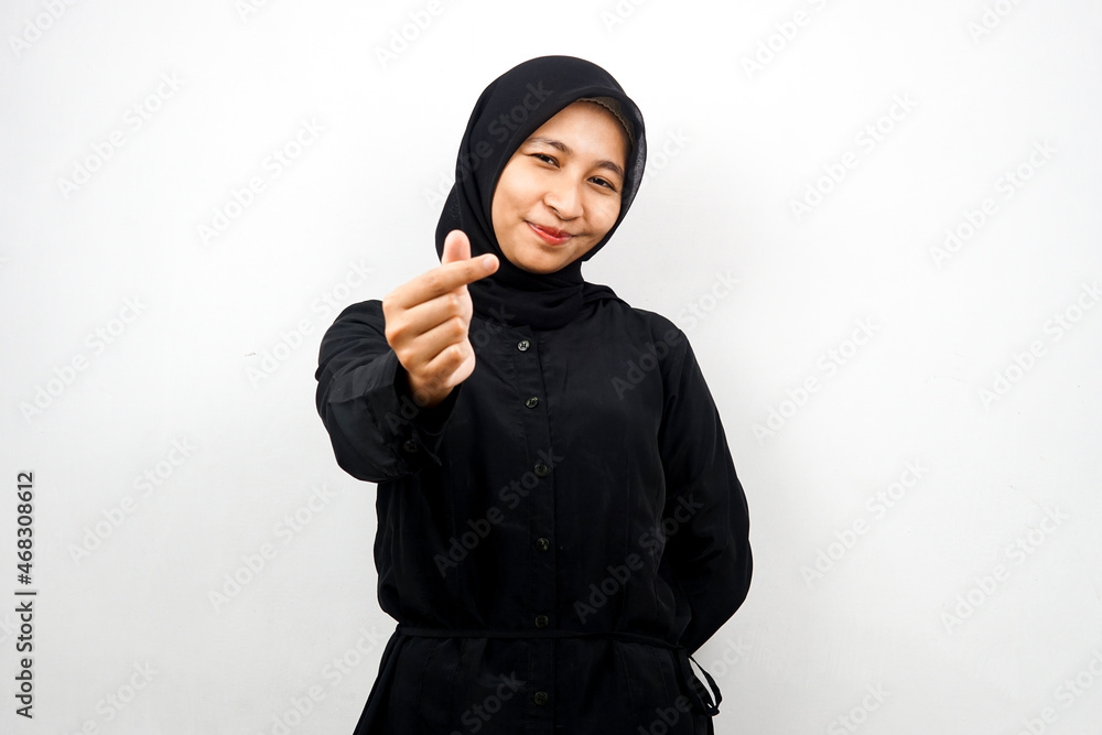 Beautiful young asian muslim woman smiling, with korean love sign hand, hand close to camera, isolated on white background Beautiful young asian muslim woman smiling, with korean love sign hand, hand close to camera, isolated on white background