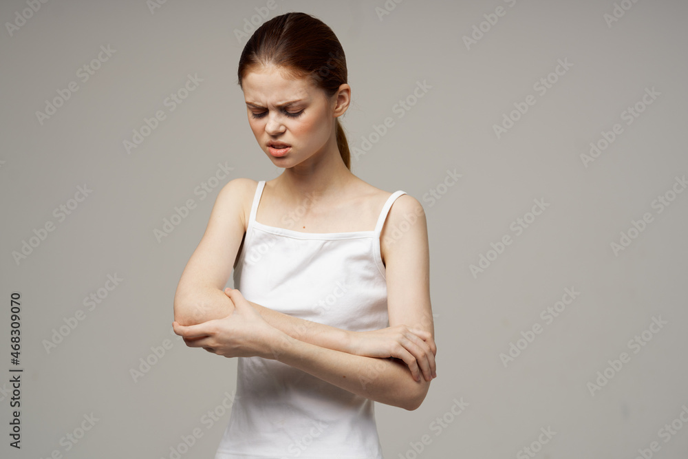 disgruntled woman elbow pain arthritis chronic disease light background disgruntled woman elbow pain arthritis chronic disease light background