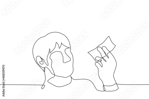 male looking one bill in his hand or at lottery ticket - one line drawing vector. concept of receiving small salary or insufficient earnings, desperate hope for the last chance