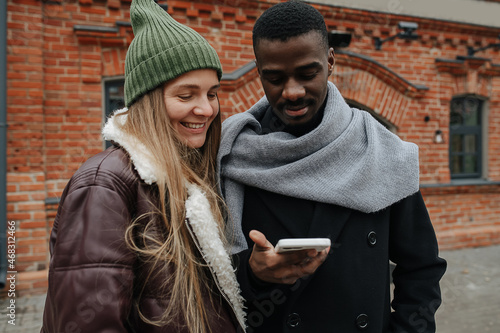Foto Man showing something on his phone to his girl-friend, both smile