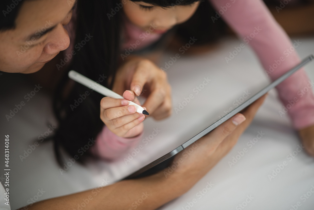 Asian children learning from home, homework learning with father and mother together in daughter family by laptop technology people, happy girl in online education lifestyle Asian children learning from home, homework learning with father and mother together in daughter family by laptop technology people, happy girl in online education lifestyle
