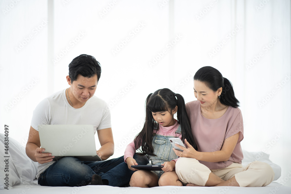 Asian children learning from home, homework learning with father and mother together in daughter family by laptop technology people, happy girl in online education lifestyle Asian children learning from home, homework learning with father and mother together in daughter family by laptop technology people, happy girl in online education lifestyle