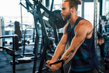 Young handsome man doing exercises in gym