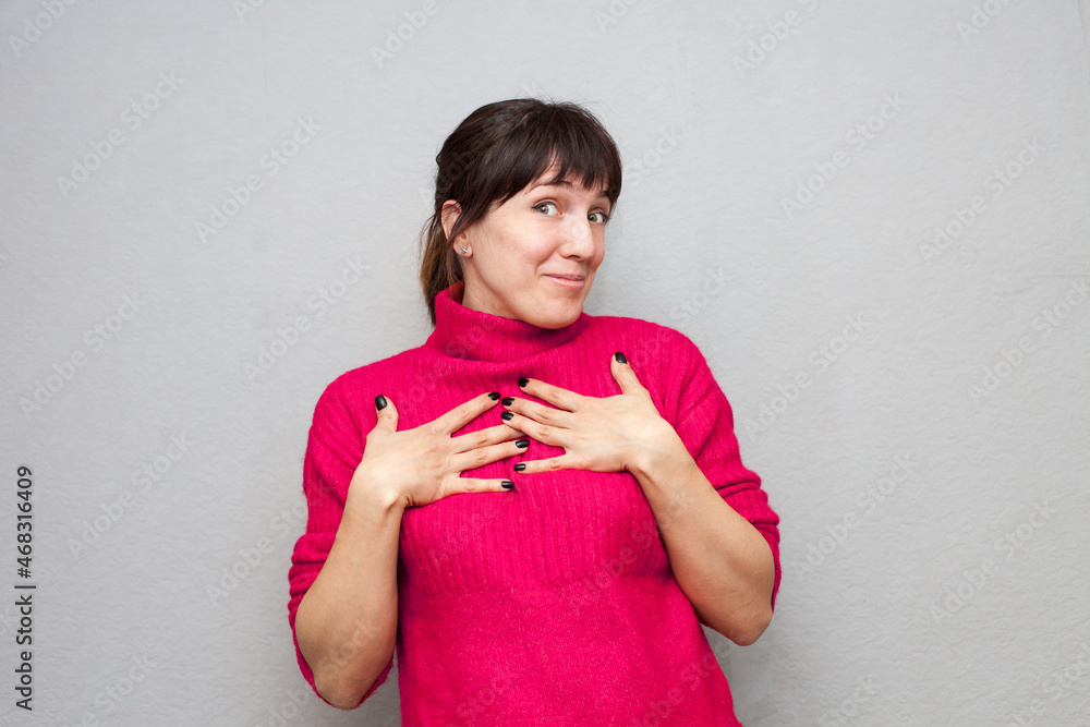 Woman in warm knitted sweater wondering Woman in warm knitted sweater wondering