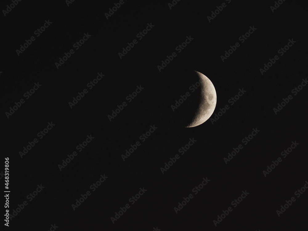 Telephoto of the waning moon in the early morning hours, space for text Telephoto of the waning moon in the early morning hours, space for text