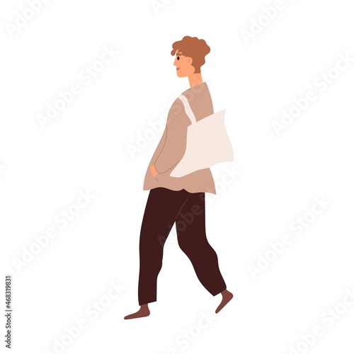 Modern man walking with tote bag. Young person going in casual clothes outdoo...