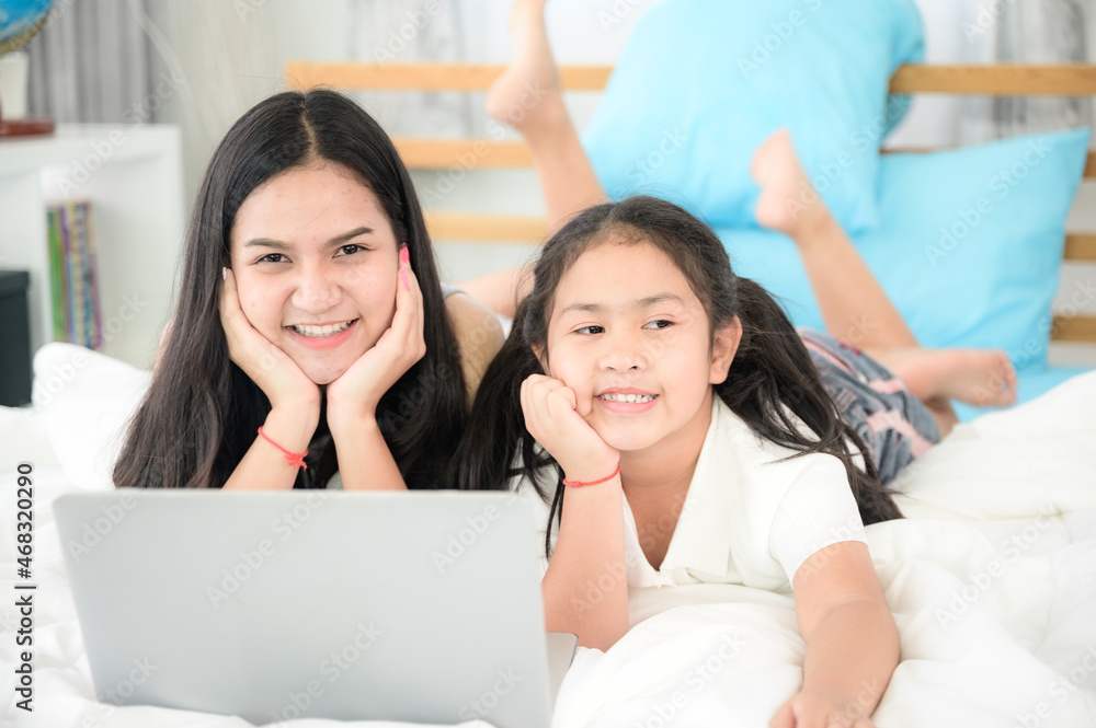education at home, young mother and child family learning to work a homework with laptop education at home, young mother and child family learning to work a homework with laptop