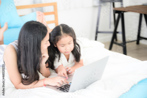 education at home, young mother and child family learning to work a homework with laptop