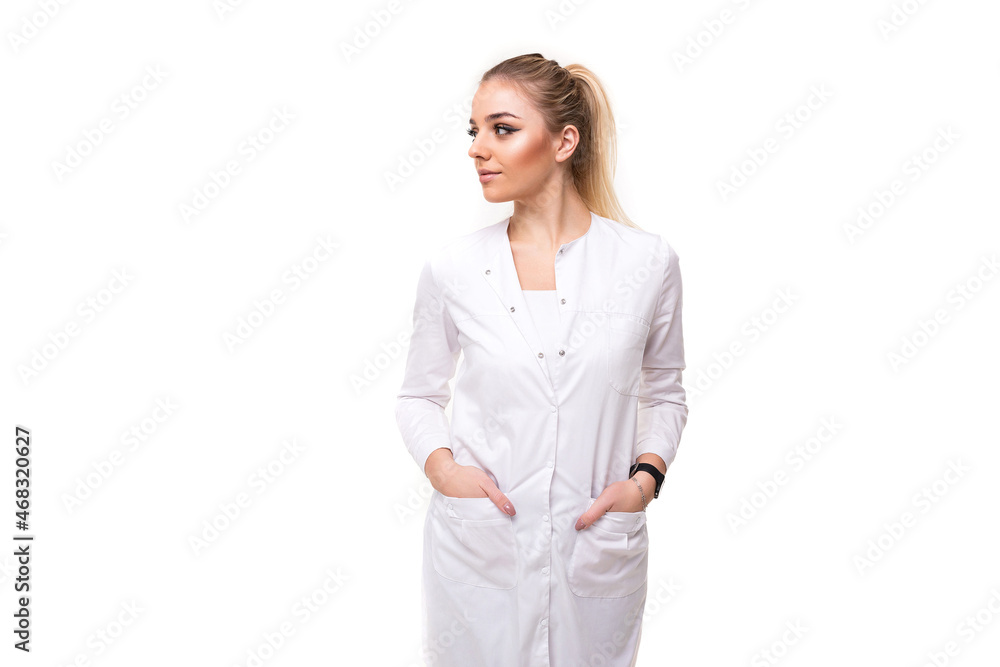 Photo of a beautiful pretty attractive young blonde woman with a ponytail and makeup in a white medical coat of a nurse isolated on a white background with free and copy space for text Photo of a beautiful pretty attractive young blonde woman with a ponytail and makeup in a white medical coat of a nurse isolated on a white background with free and copy space for text