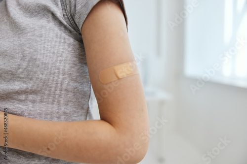 plaster on a woman's hand close-up vaccine passport
