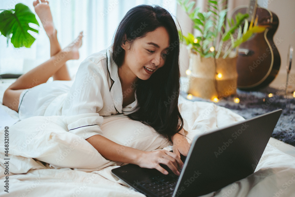 young Asian woman using laptop computer to business online work, female freelance working from home by using internet cyberspace communication technology for businesswoman job young Asian woman using laptop computer to business online work, female freelance working from home by using internet cyberspace communication technology for businesswoman job