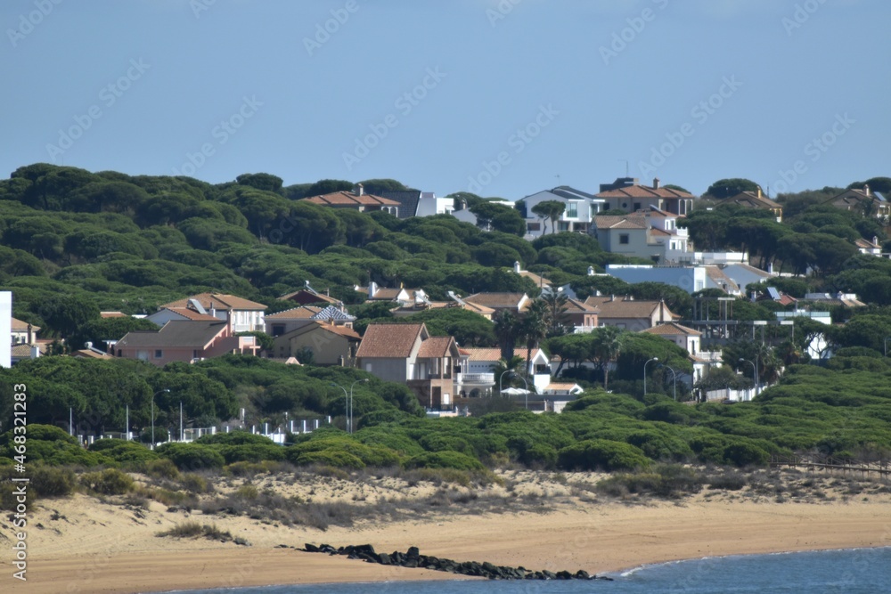 Some houses, trees, sand and the sea in the coast of Huelva,Spain