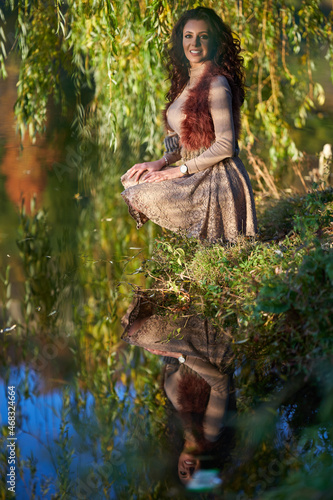 Woman by the lake and willow tree
