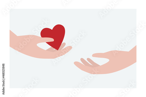 Giving a heart from one hand to another. Concept of love or charity.