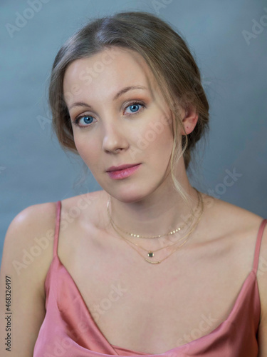 portrait of actress Yanna Mazazolina on a gray-blue background