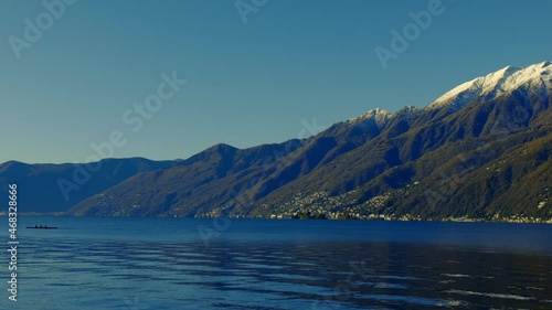 Wallpaper Mural Canoe on Alpine Lake Maggiore with Snow-capped Mountain with Clear Blue Sky in a Sunny Day in Ascona, Ticino, Switzerland. Torontodigital.ca
