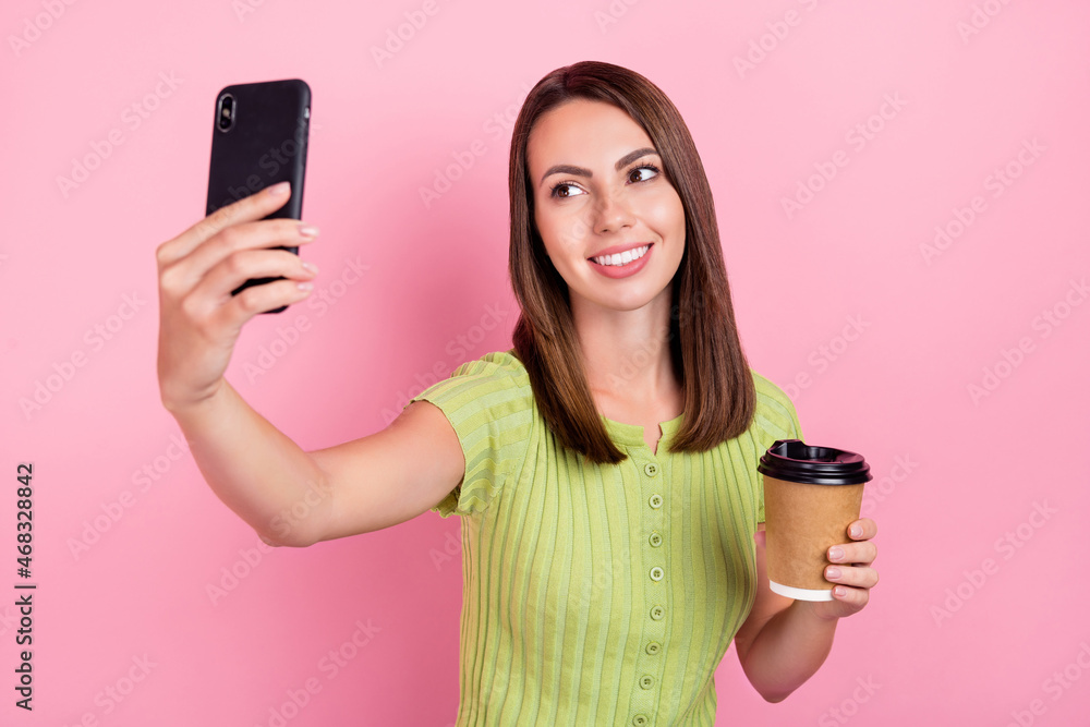 Photo of sweet brunette young lady drink coffee do selfie wear green t-shirt isolated on pink color background Photo of sweet brunette young lady drink coffee do selfie wear green t-shirt isolated on pink color background