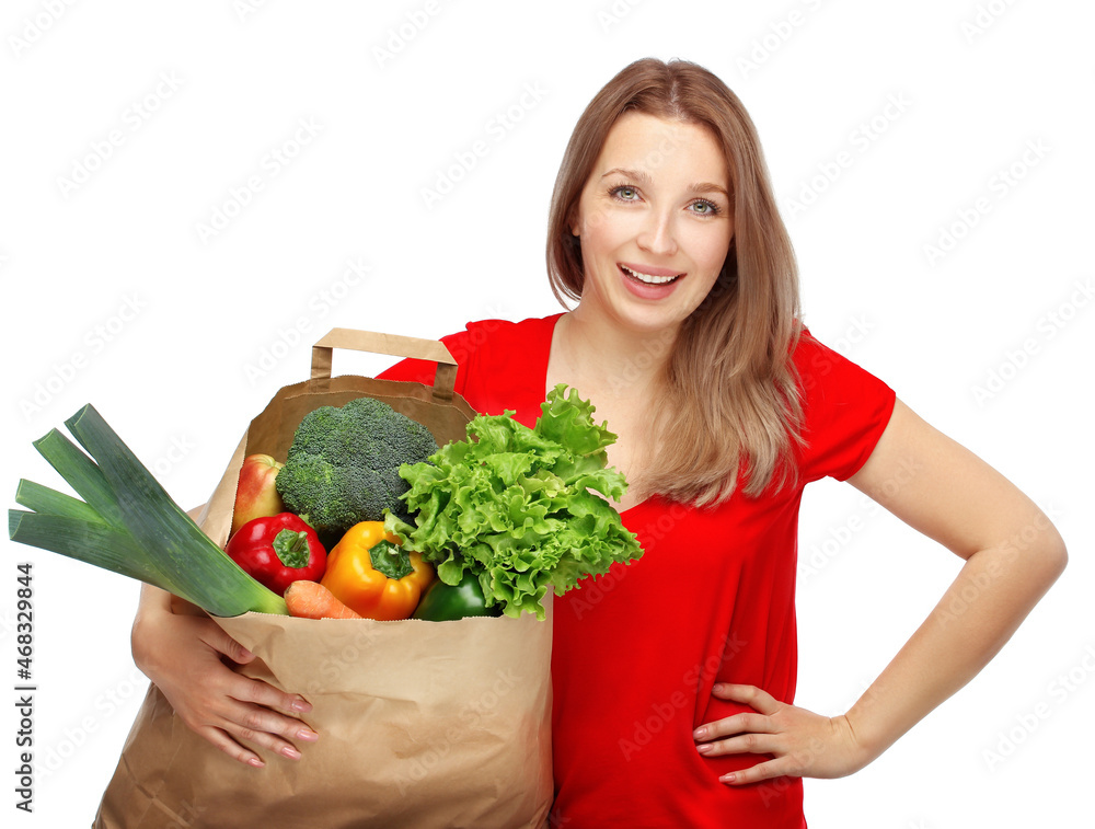 Girl with vegetable groceries .young woman holding a bag of groceries from the grocery store Girl with vegetable groceries .young woman holding a bag of groceries from the grocery store