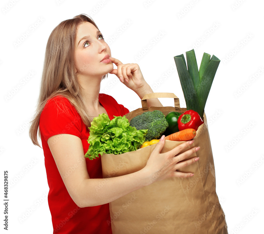 Girl with vegetable groceries .young woman holding a bag of groceries from the grocery store Girl with vegetable groceries .young woman holding a bag of groceries from the grocery store